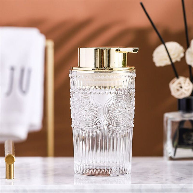 Elegant såpedispenser i glass med gulldetaljer