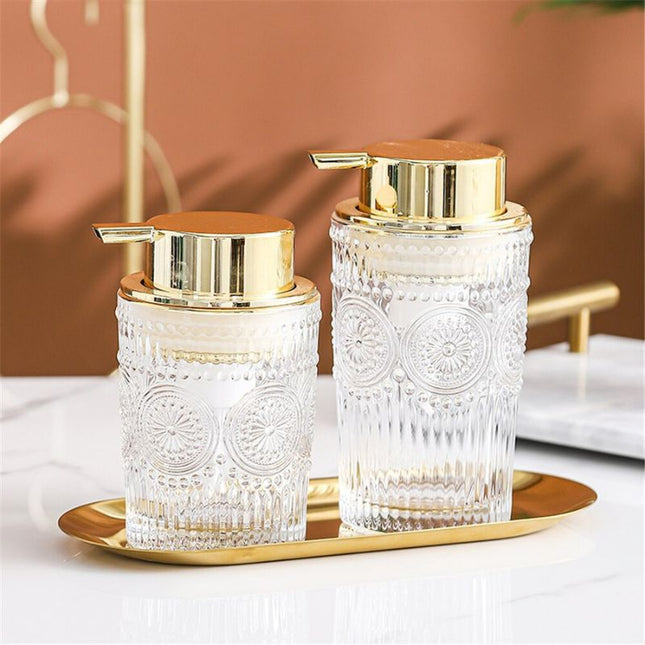 Elegant såpedispenser i glass med gulldetaljer