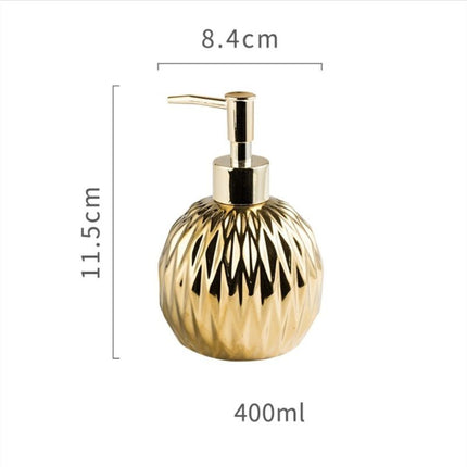 Rund gullfarget såpedispenser med mønster