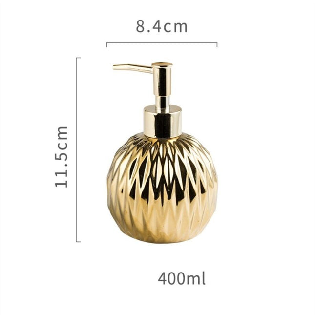 Rund gullfarget såpedispenser med mønster
