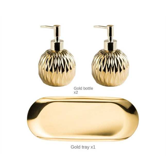 Rund gullfarget såpedispenser med mønster