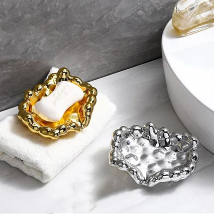 Design såpeholder i gullfarget skyform